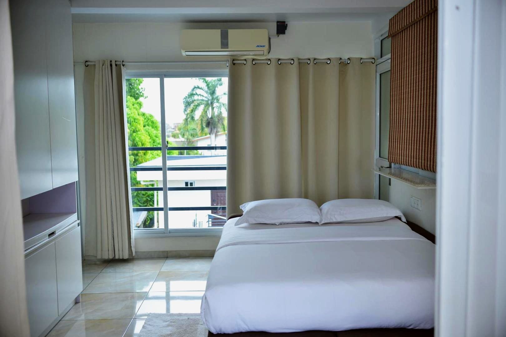 Bed beside the window in a studio
