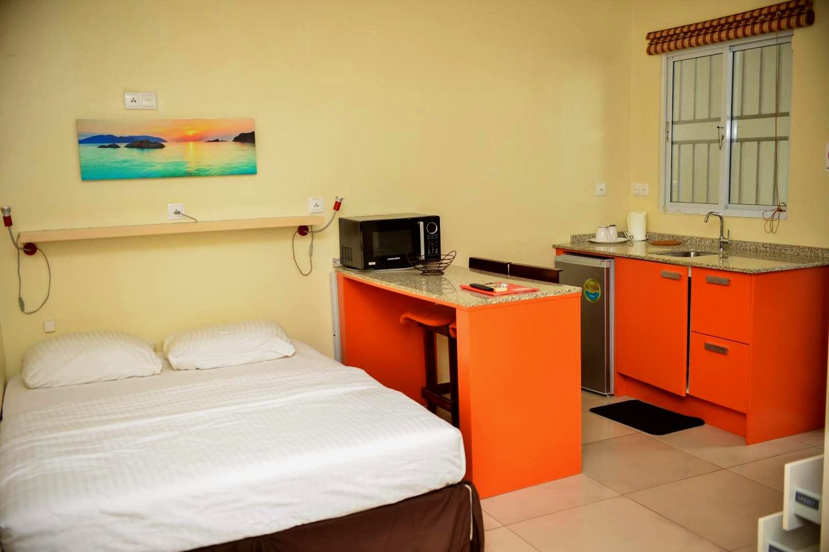 Studio at Elementz Apartments with a queen bed and a fitted kitchen